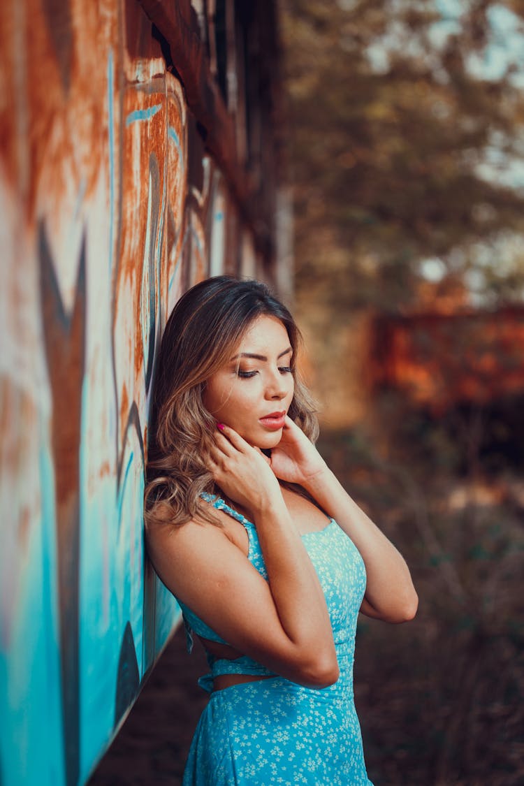 Woman In Dress Posing Near Wall