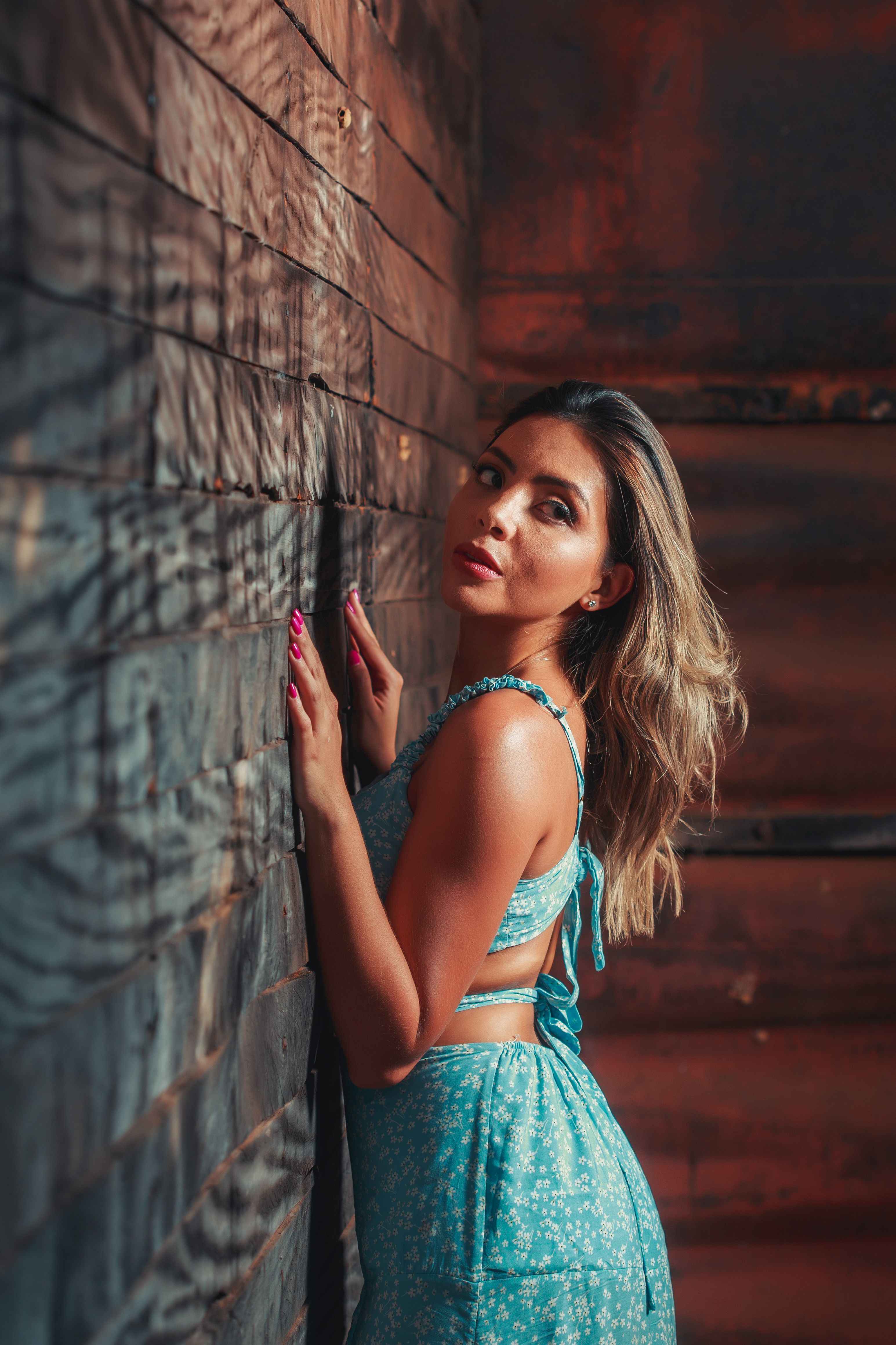 Woman in Blue Dress Posing on a Wall · Free Stock Photo