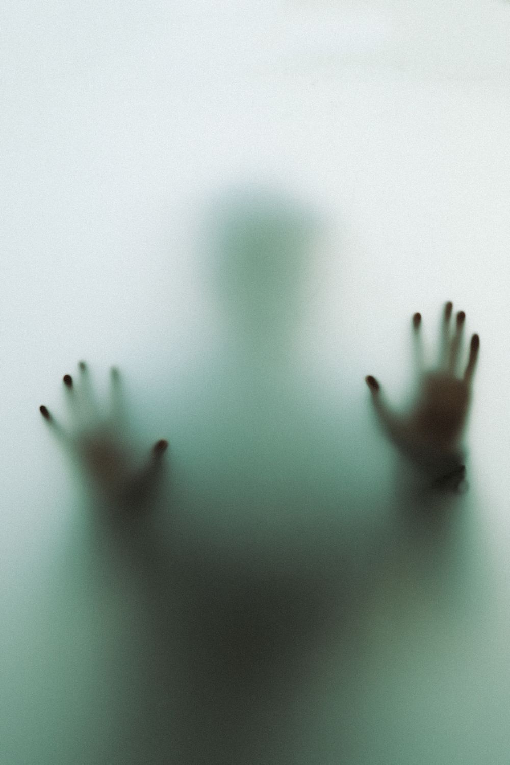 Hands and Silhouette of Person behind Glass · Free Stock Photo