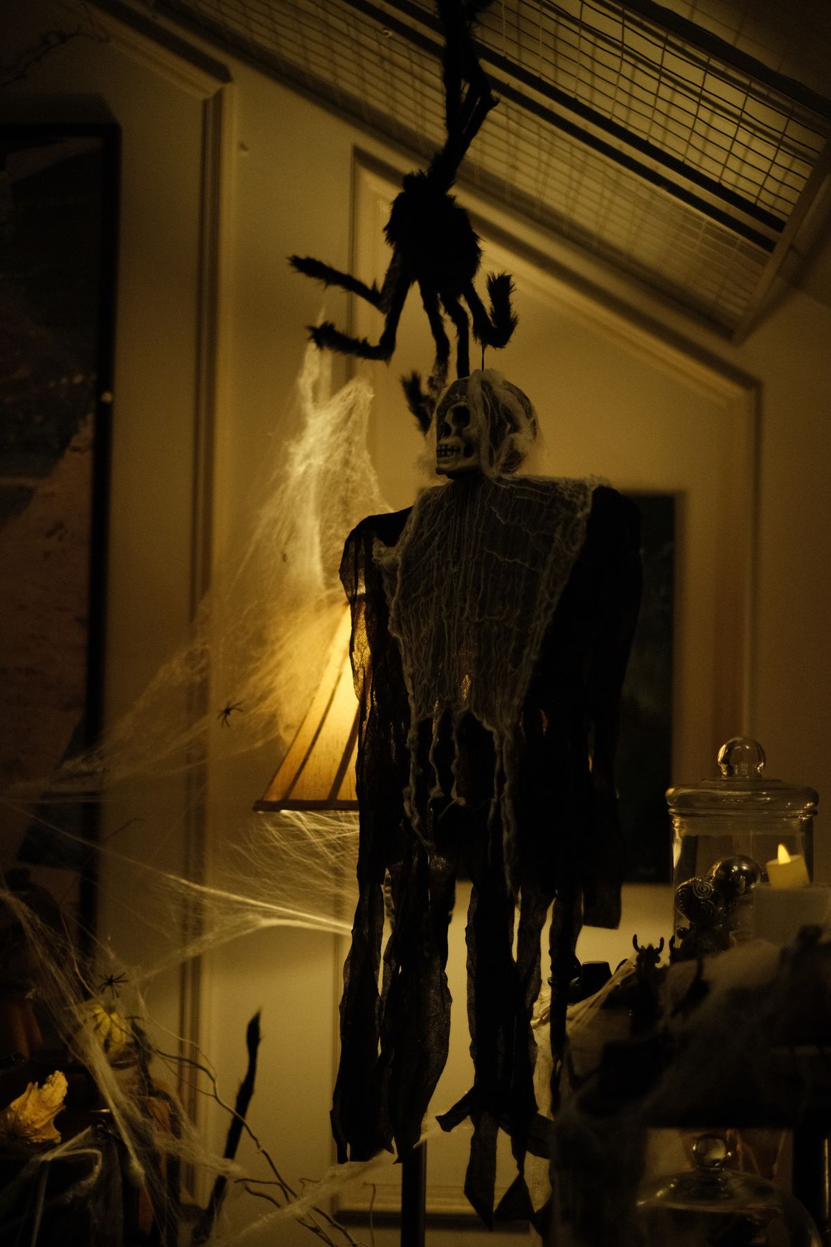 Spooky skeleton Halloween decoration with cobwebs on a mantel