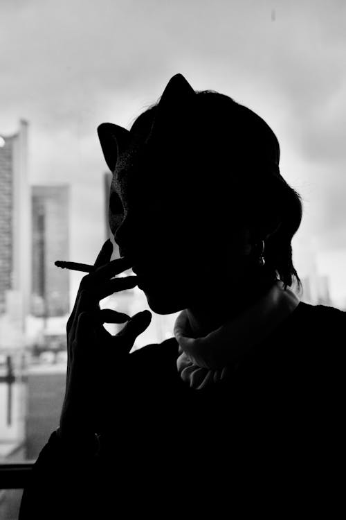 Silhouette of a Person Smoking Cigarette