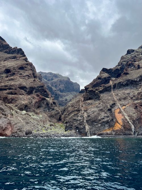 Free Overcast view of rugged cliffs meeting the Atlantic Ocean in Tenerife, Spain. Stock Photo