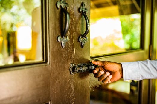Man Holding Door Latch