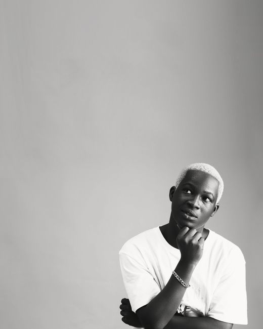 Artistic black and white portrait of a man thinking in Lagos studio.