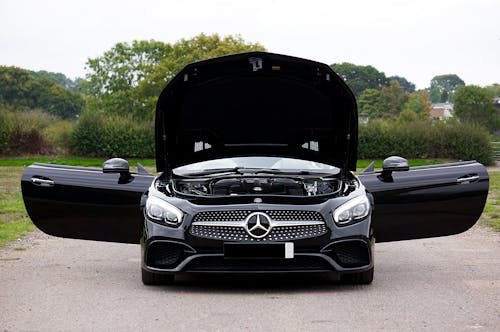 Black Mercedes-Benz with a Raised Hood and Opened Door 