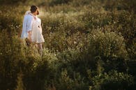 一对夫妇在越南郁郁葱葱的田野里拥抱，捕捉日落时的宁静时刻