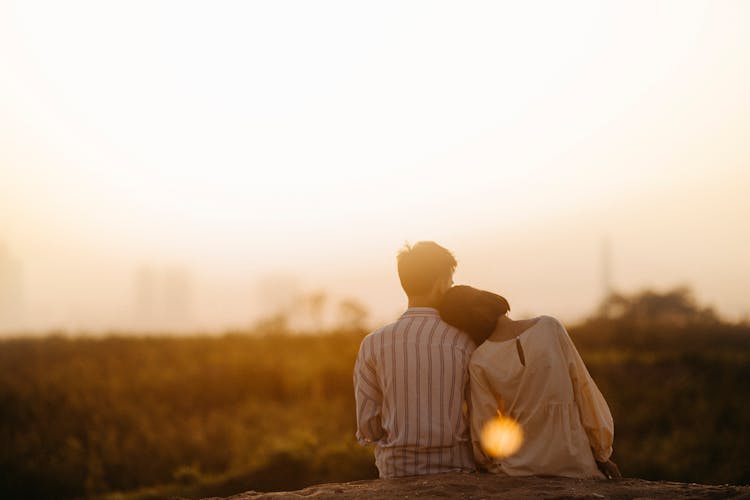 Man And Woman Near Grass Field