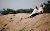 Free Man and Woman Sitting on the Sand Stock Photo