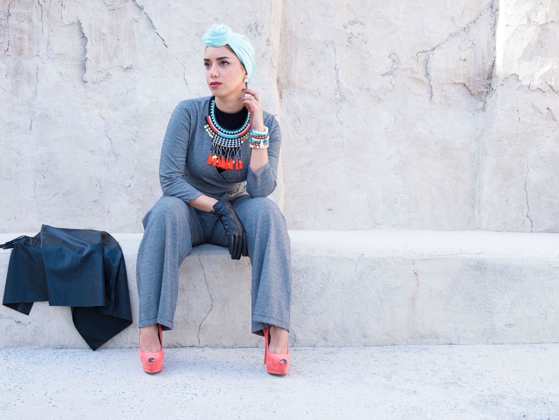 Fashionable woman in vibrant attire posing outdoors in Dubai, blending modern and traditional style.