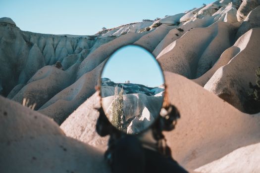 Mirror reflecting unique rock formations in Cappadocia, creating a surreal visual effect.