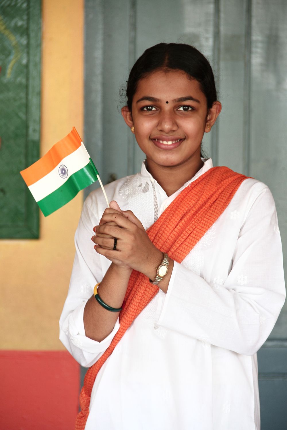 Sarath Raj A Woman in White Long Sleeves Holding an Indian Flaglet · Free Stock Photo