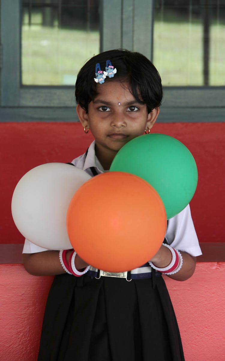 Cute Indian School Girl With Tricolour Indian Flag