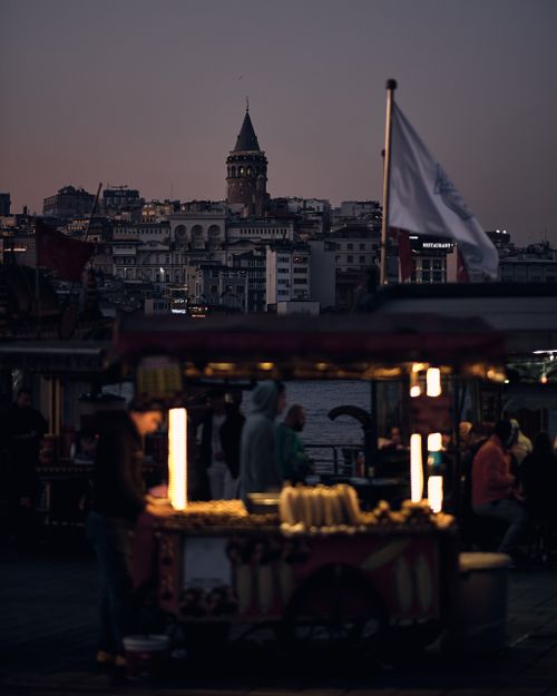 Free Captivating night view of the illuminated Galata Tower in Istanbul with a vibrant street market. Stock Photo