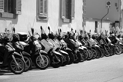 Grayscale Photo of Motorcycles Parked on the Road