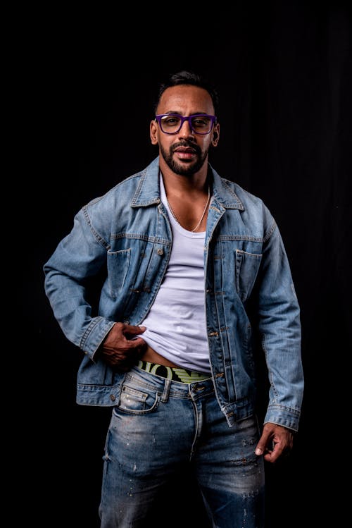 A Man in White Tank Top and Denim Jeans