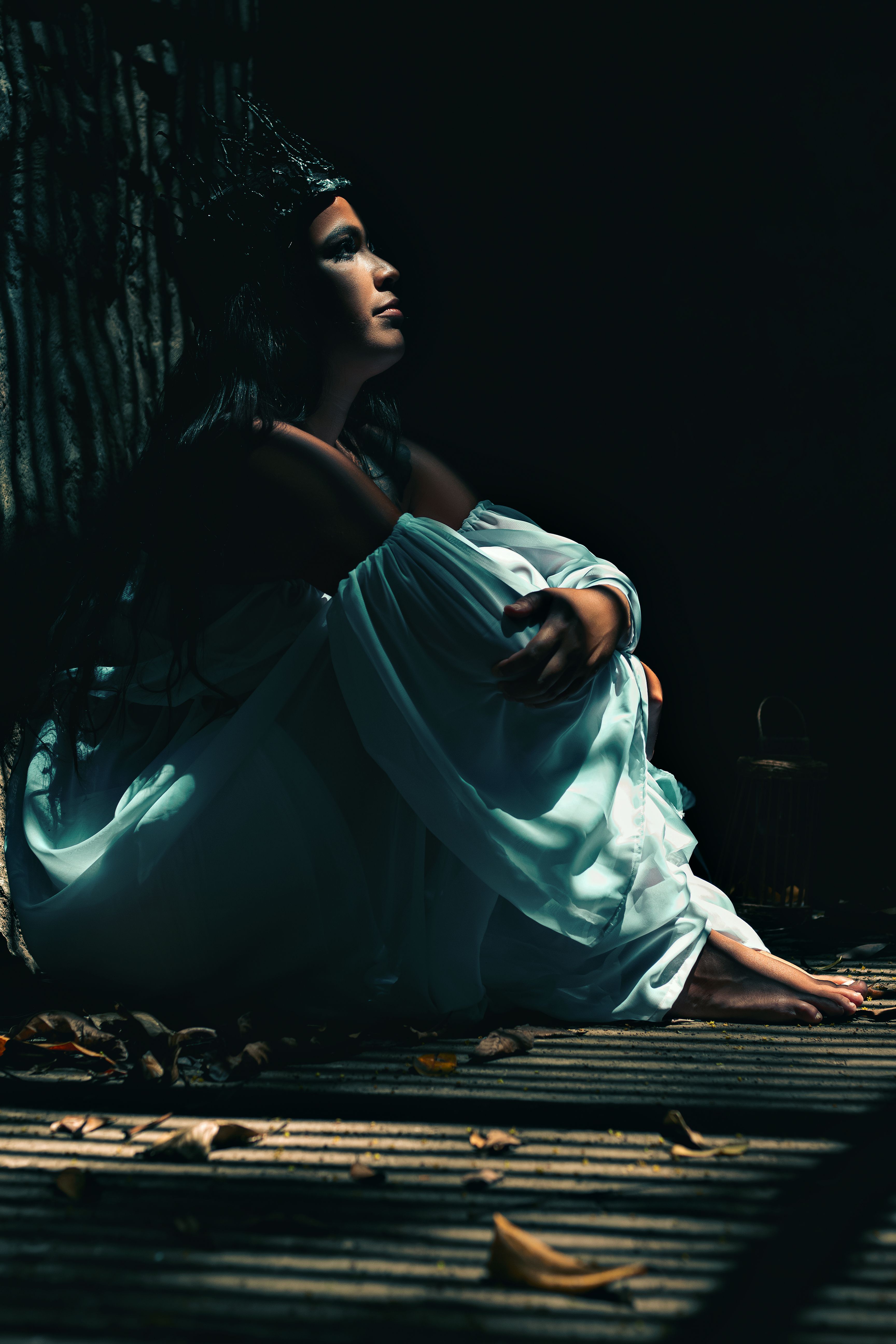 A Woman in Blue Dress Sitting on the Street · Free Stock Photo