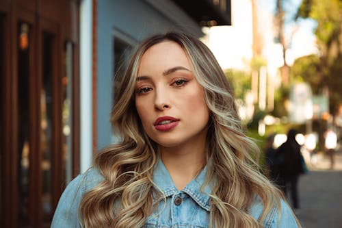 A Beautiful Woman in Denim Shirt with Curly Hair