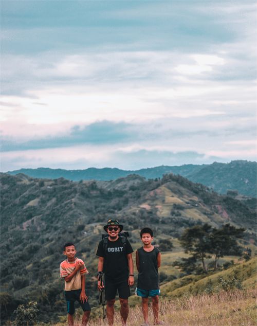Free A man with two boys standing in hilly terrain in Cebu City, Philippines. Stock Photo