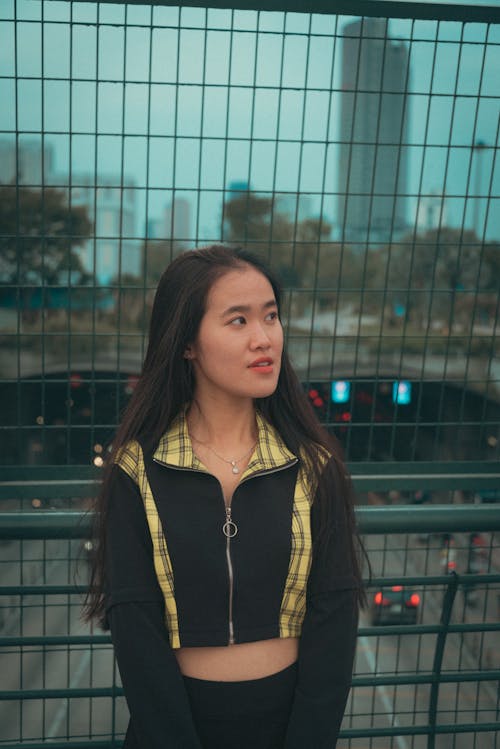 Woman in Crop Top Posing on Metal Railings