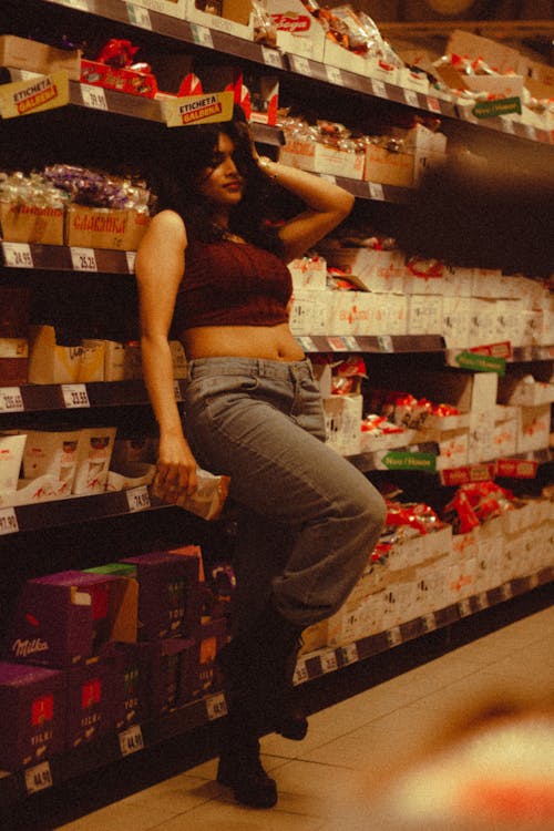 A Woman in a Crop Top Leaning in a Grocery Store