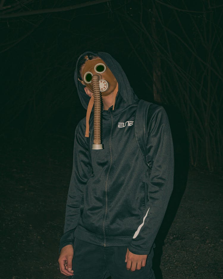 Man In Black Hoodie Wearing Brown Gas Mask