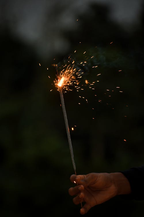 Hand Holding Flaming Firework