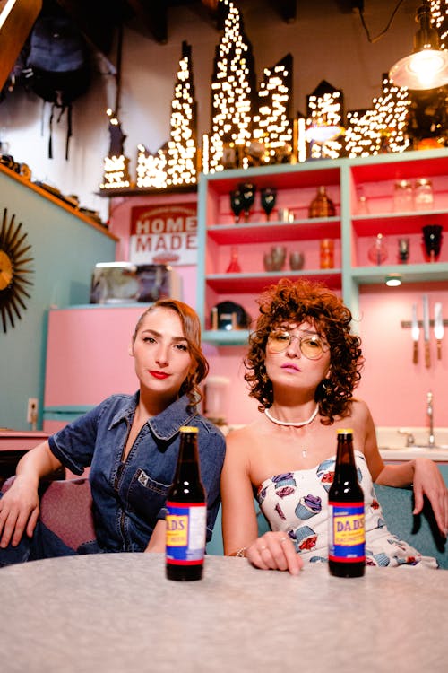 Free Women with Bottles on Vintage Kitchen Stock Photo