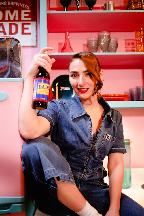 Free Woman with Bottle in Retro Kitchen Stock Photo