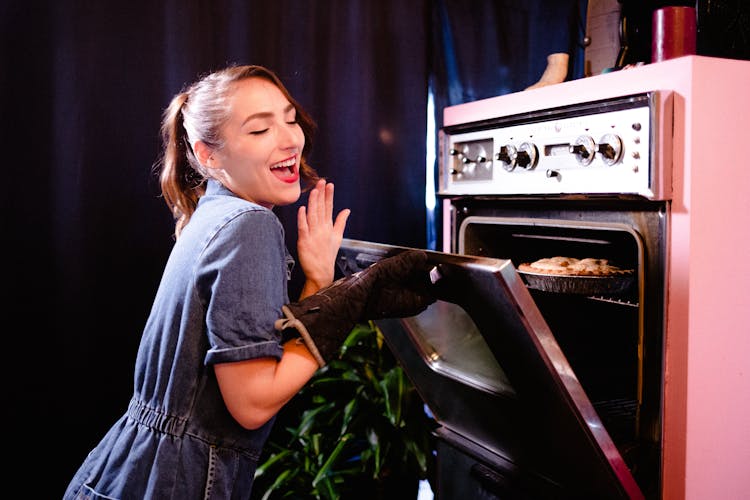 Smiling Woman Baking In Retro Kitchen