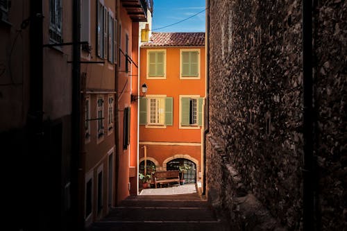 A Dark Alley Between Orange Houses