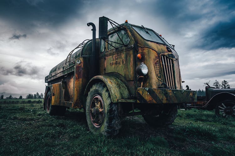 An Old Truck In A Field 