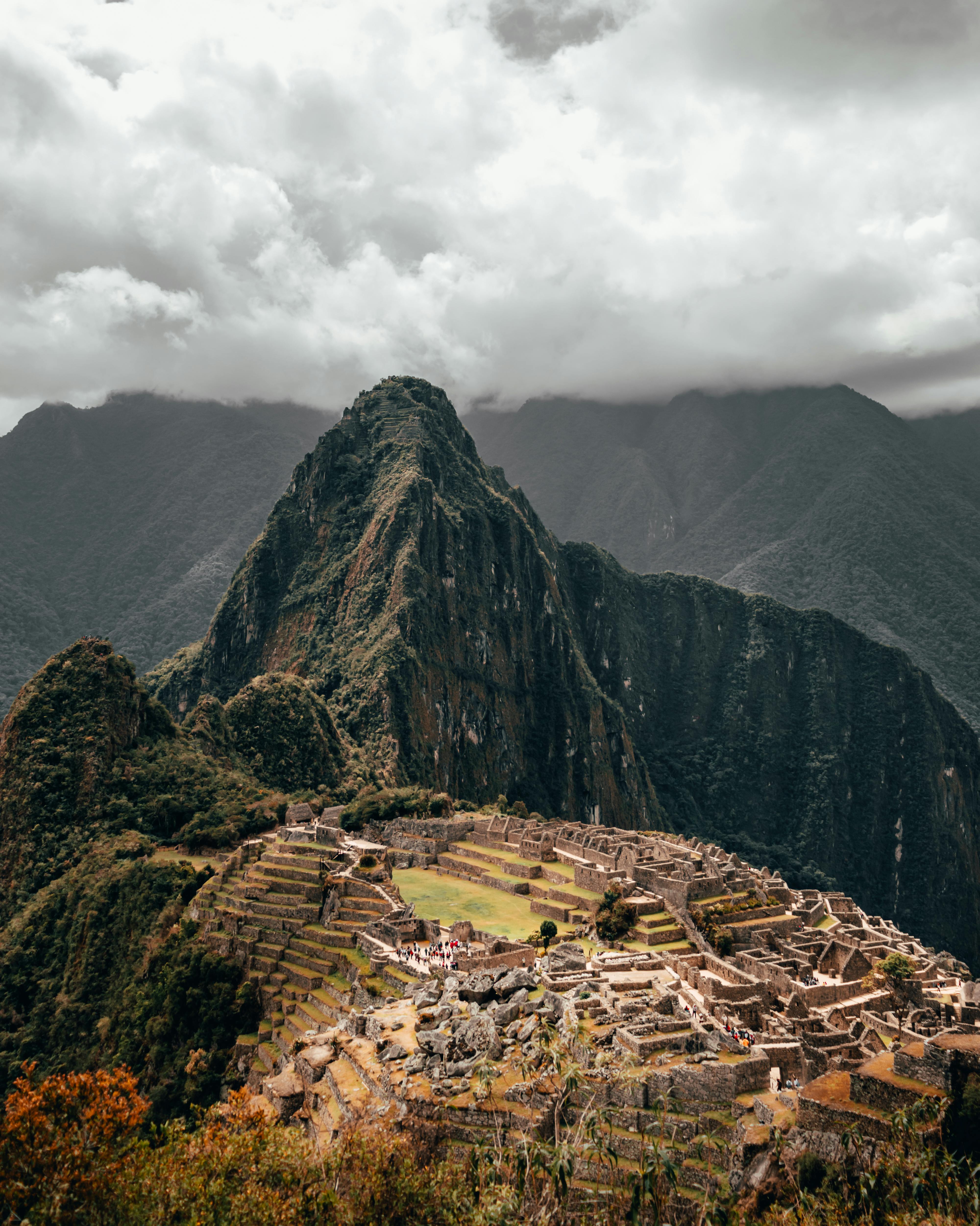 Stunning aerial view of Machu Picchu under cloudy skies in Cusco, Peru.
