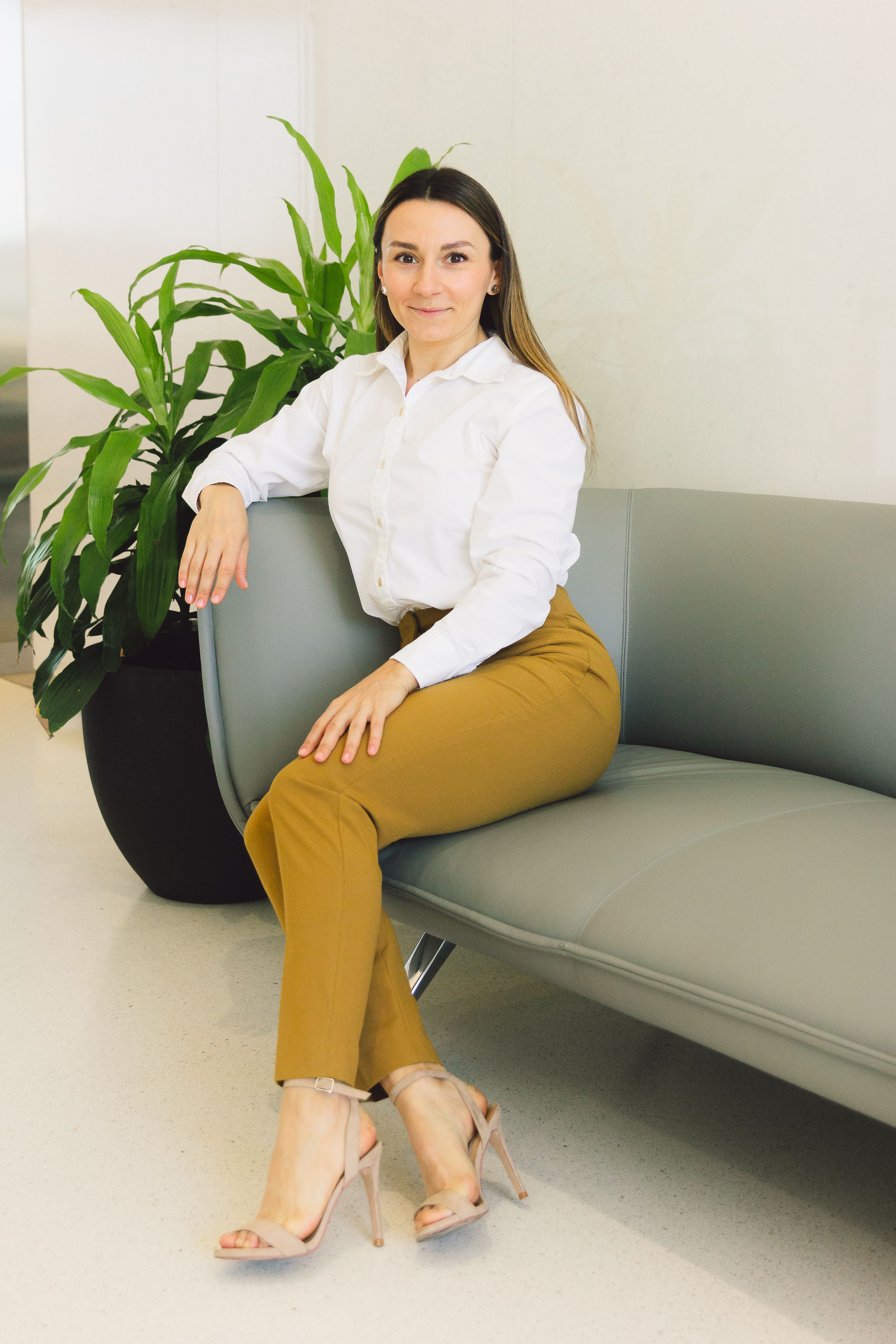 A Woman in White Long Sleeves and Yellow Pants Sitting on the Couch ...