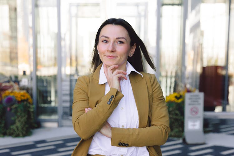 A Woman Wearing A Brown Suit Standing