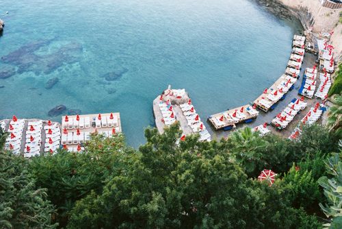 Free Stunning aerial view of a beach resort with sun loungers and umbrellas by the sea. Stock Photo