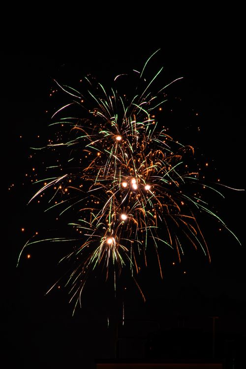 Free Bright fireworks light up the night sky with colorful sparks and pyrotechnics. Stock Photo