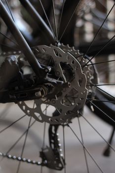 Detailed shot of a bicycle's brake and wheel components in black and white.