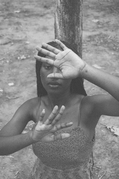 Portrait of Woman with Hands Raised