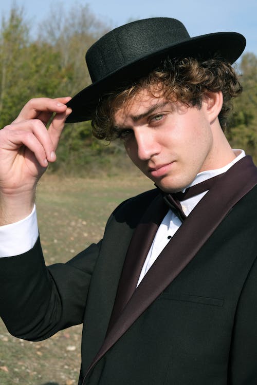 Man in Suit and Hat Posing in Nature