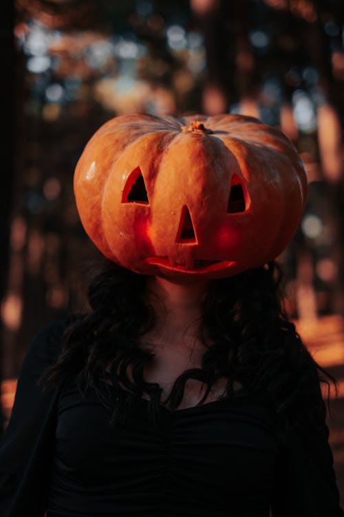 A Woman in Black Long Sleeve Wearing Jack O Lantern