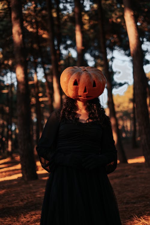 A Woman in Black Dress Wearing Jack O Lantern