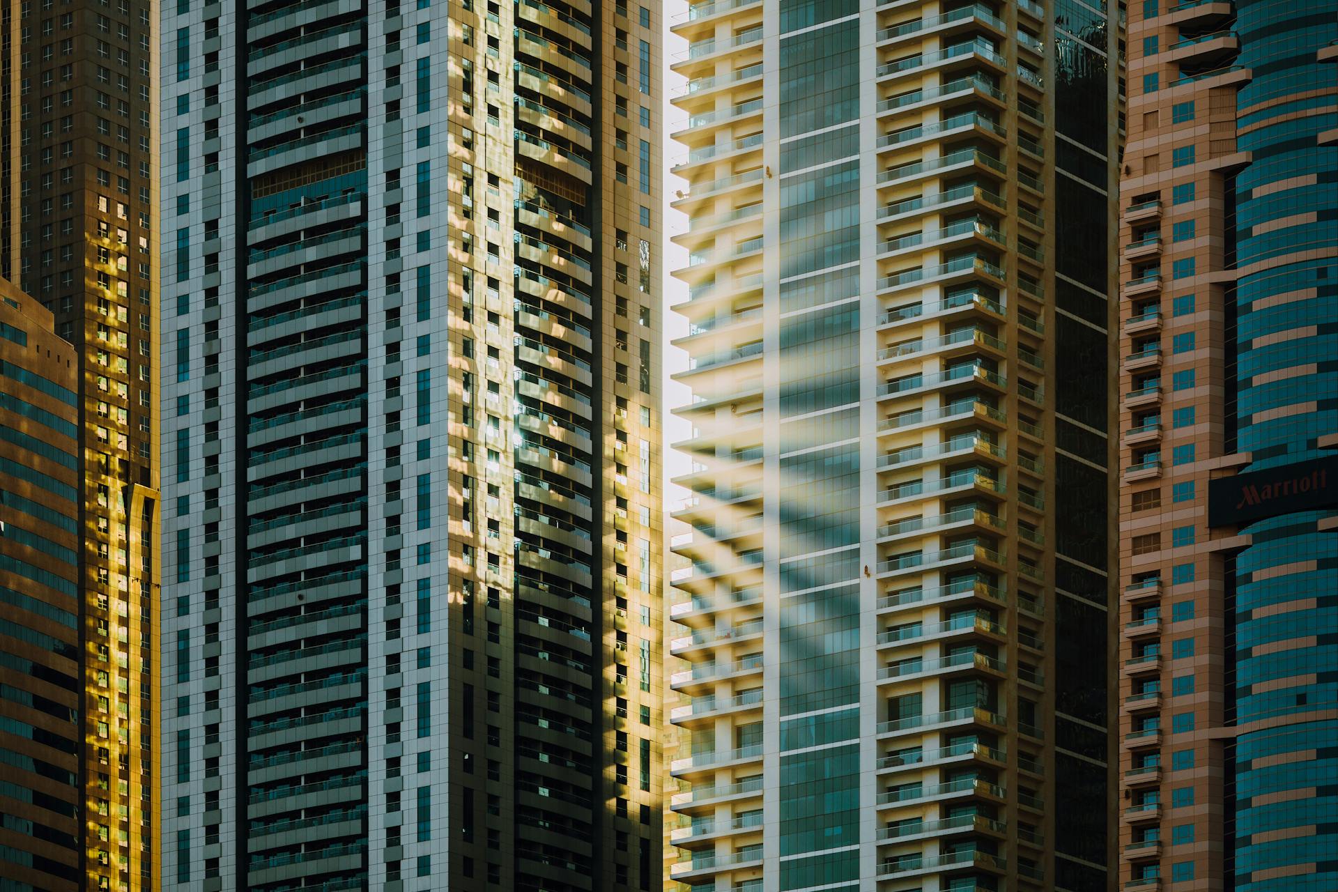 Stunning view of modern skyscrapers in Dubai reflecting sunlight, showcasing contemporary architectural design.