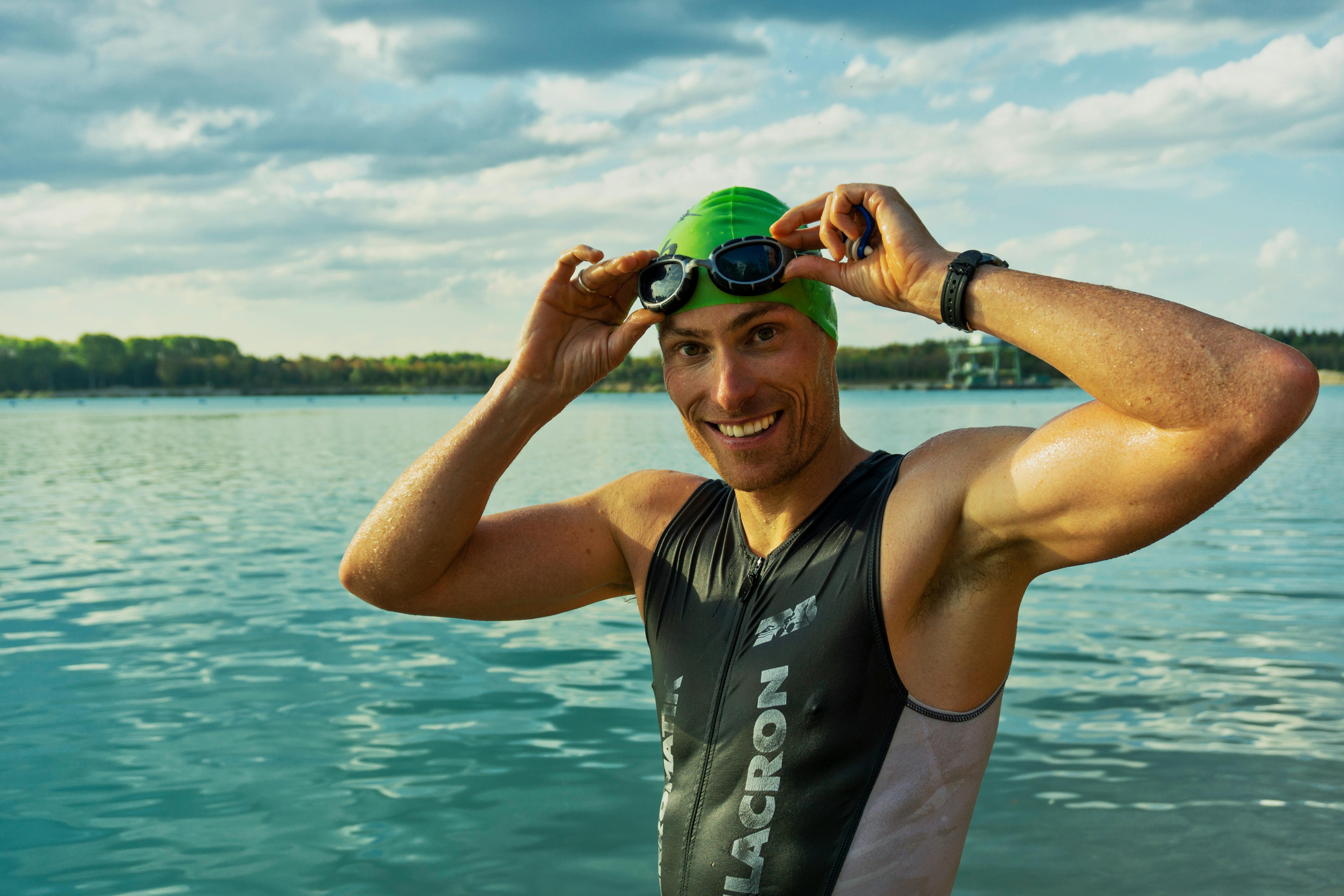 man in sleeveless wet suit and swimming goggles