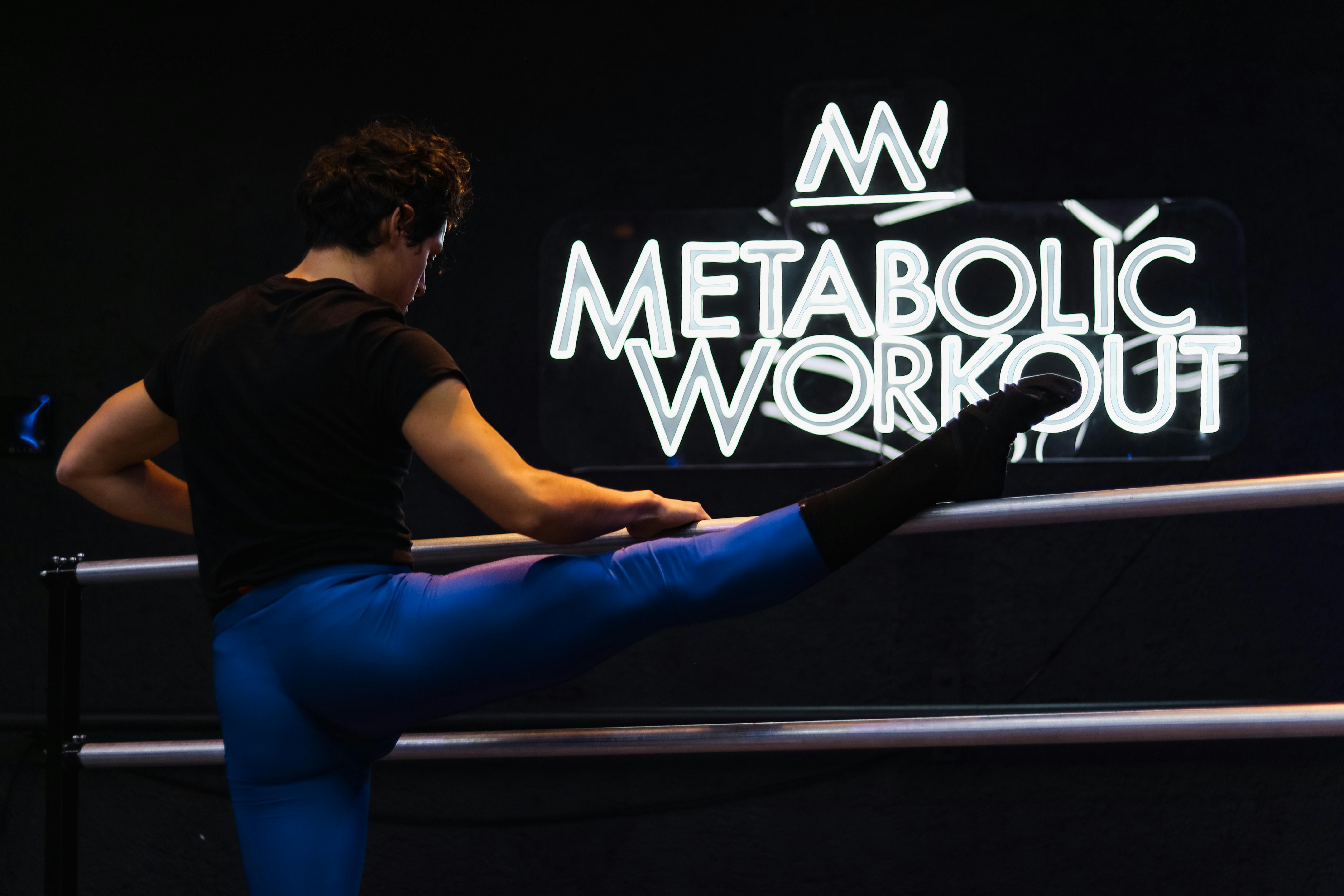 Athlete performing a leg stretch at Metabolic Workout studio in Mexico City.
