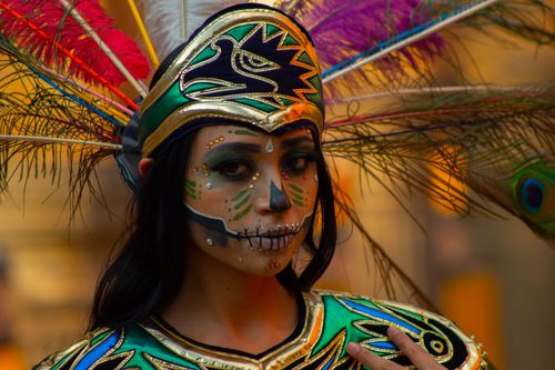 Free Close-up portrait of a woman in a colorful headdress and creative face paint, showcasing cultural expression. Stock Photo
