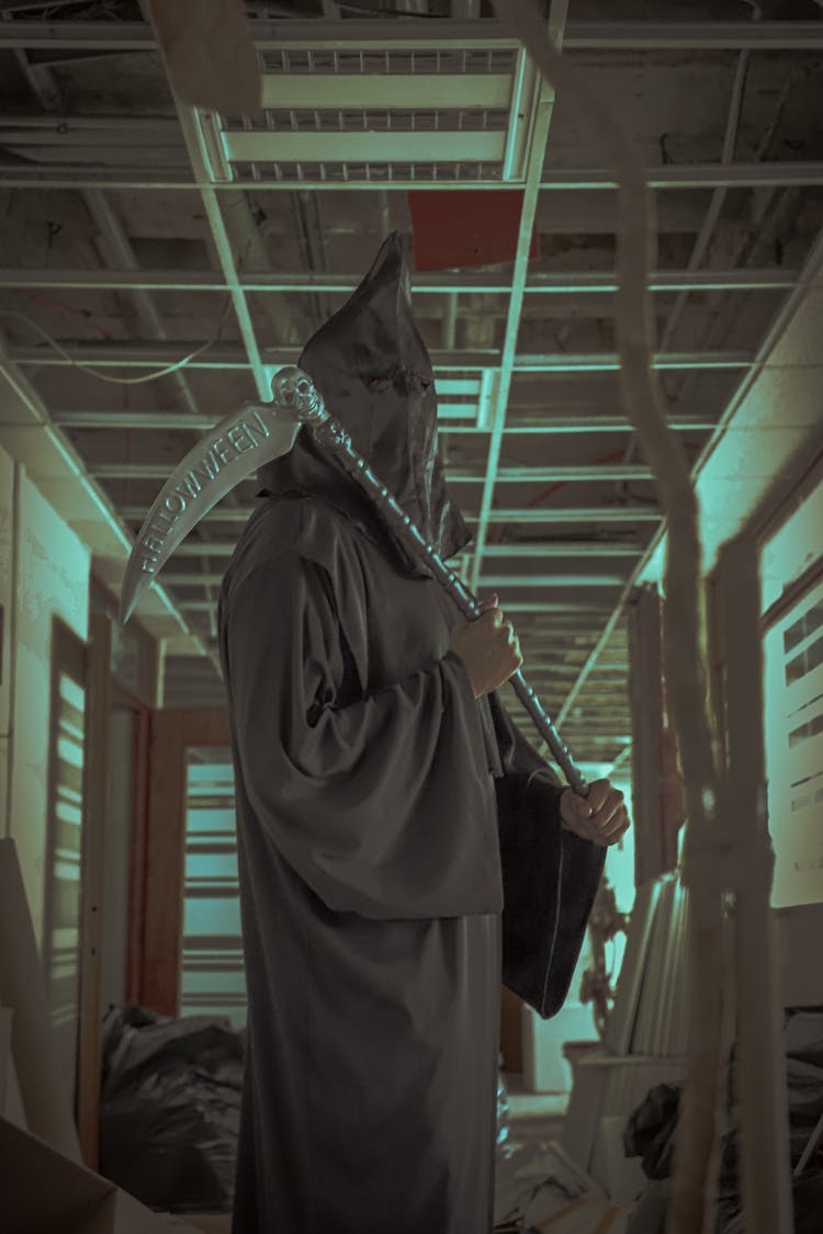 Person In Death Reaper Costume Posing In Abandoned Office