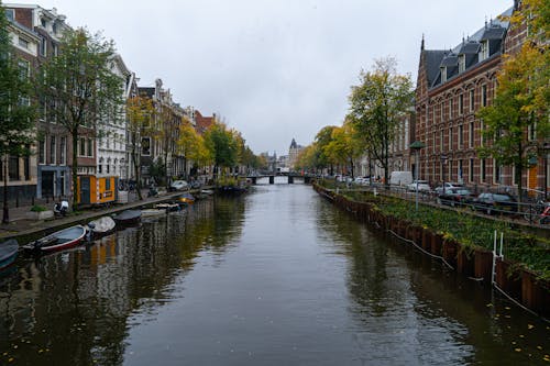 A Canal Between City Buildings