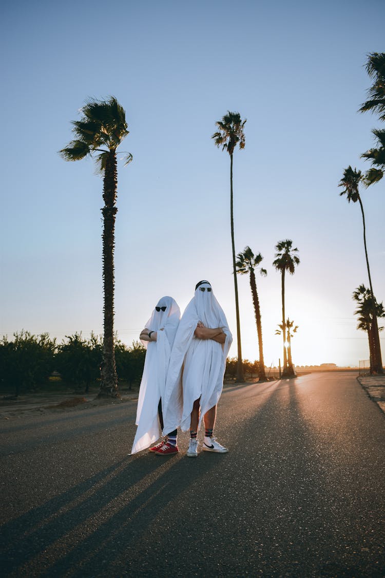 People Disguised As Ghosts Standing On Road