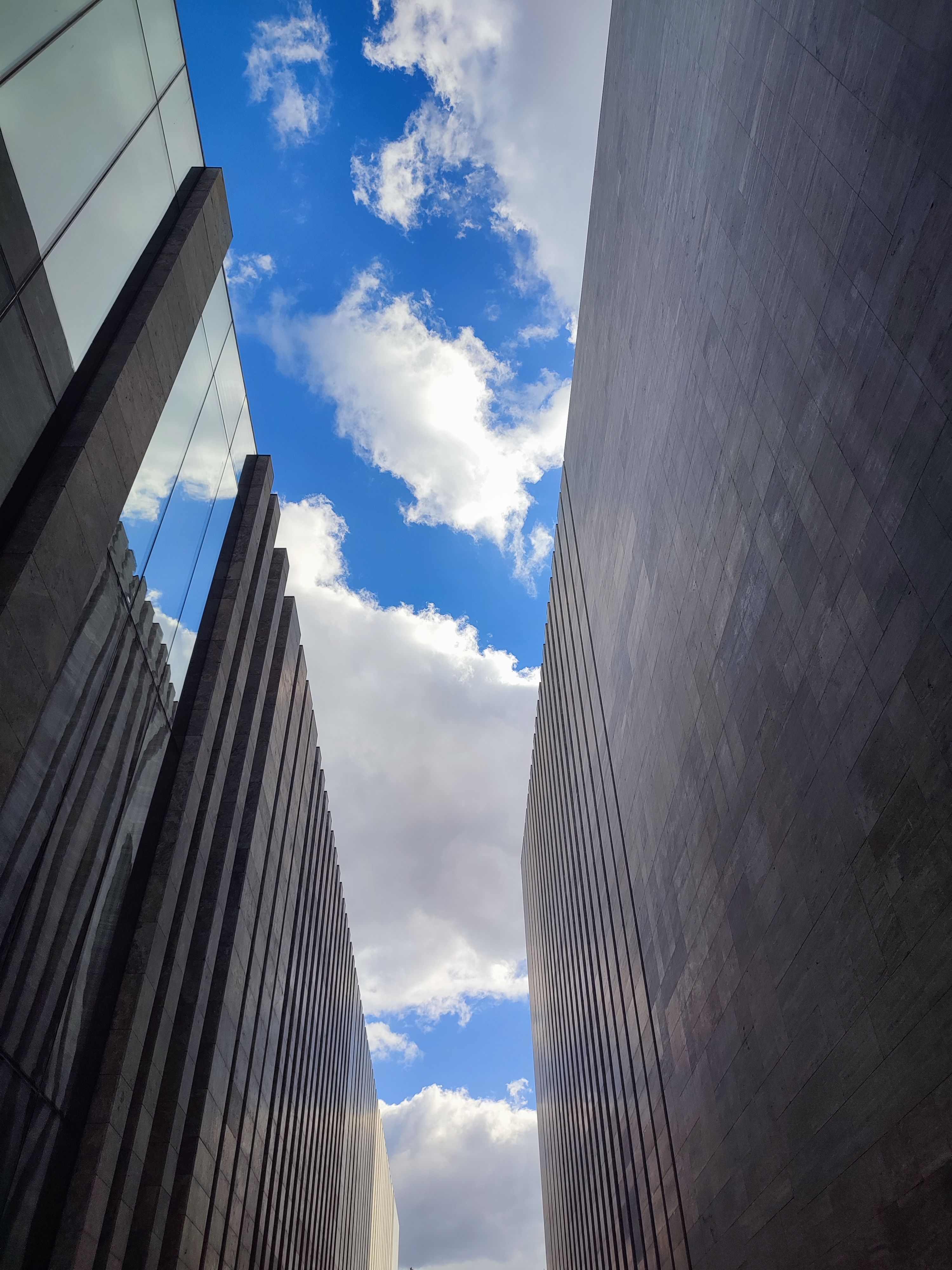 A Low Angle Shot of High Rise Buildings Under the Blue Sky and White ...