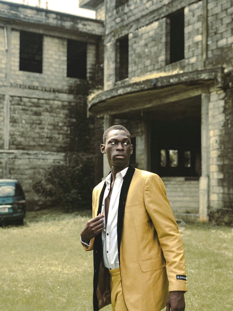 A Man In Yellow Suit Looking Over Shoulder